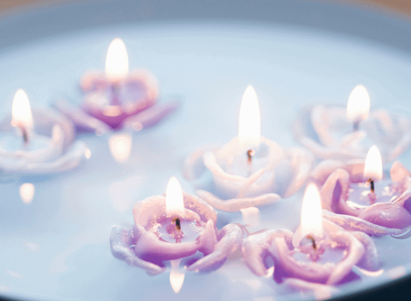 Floating rose shaped candles in a bowl